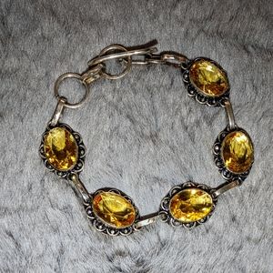 Silver bracelet with a yellow stone